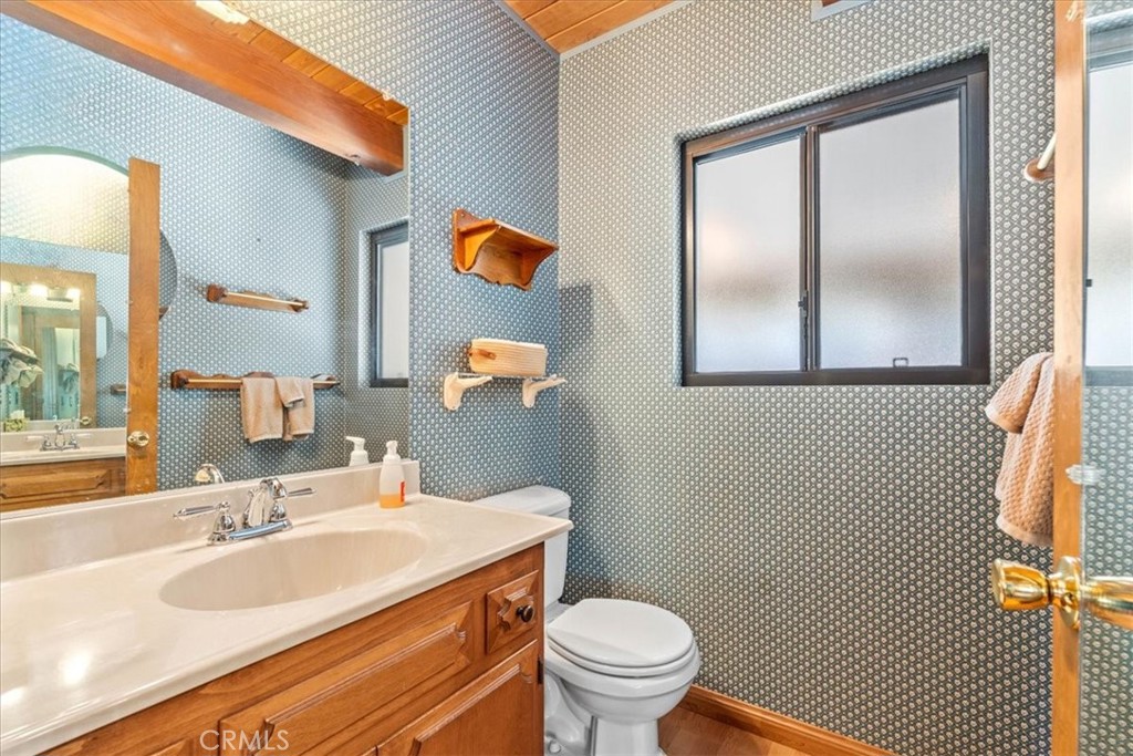 1631 Linnet Road Wrightwood, CA 92397 - Photo 26 of 42 a bathroom with a sink toilet and mirror