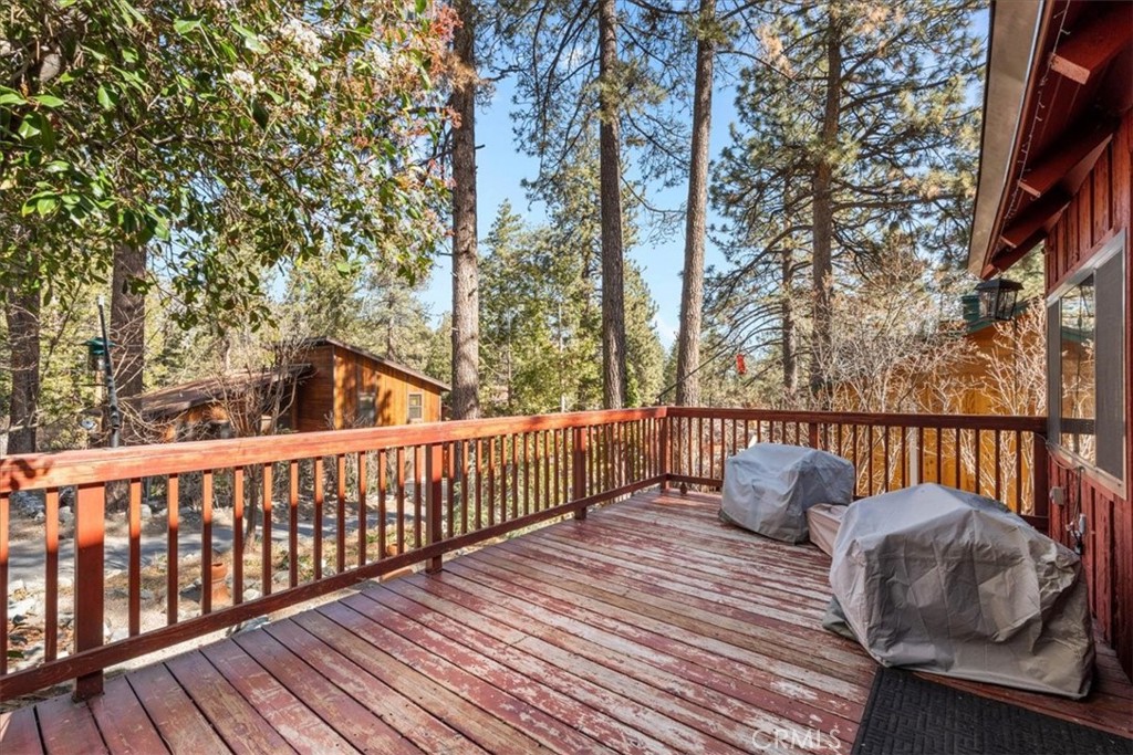 1631 Linnet Road Wrightwood, CA 92397 - Photo 8 of 42 a balcony of a house with wooden floor and fence