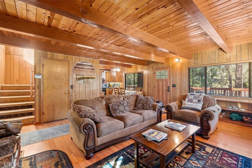 1631 Linnet Road Wrightwood, CA 92397 - Photo 10 of 42 a living room with furniture a wooden floor and a large window