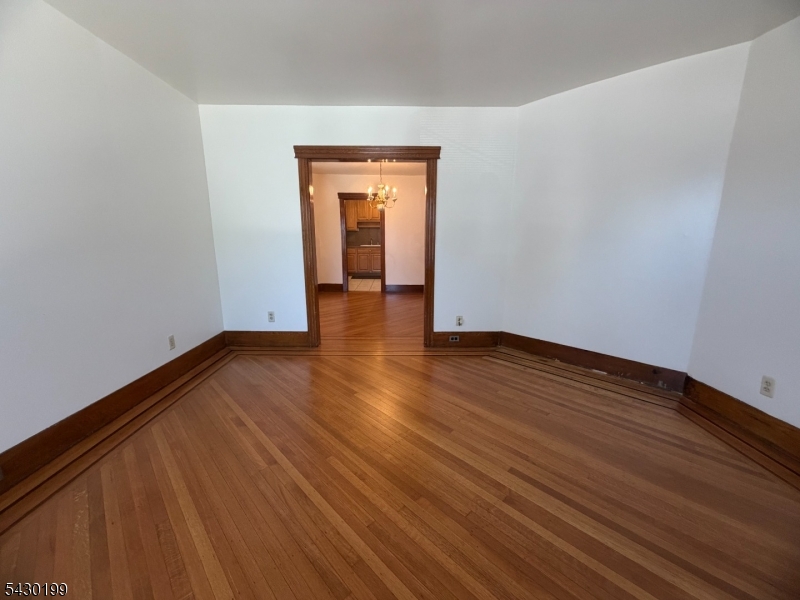 72 Baldwin Place, Unit 2 Bloomfield, NJ 07003 - Photo 14 of 24 a view of an empty room with wooden floor and closet