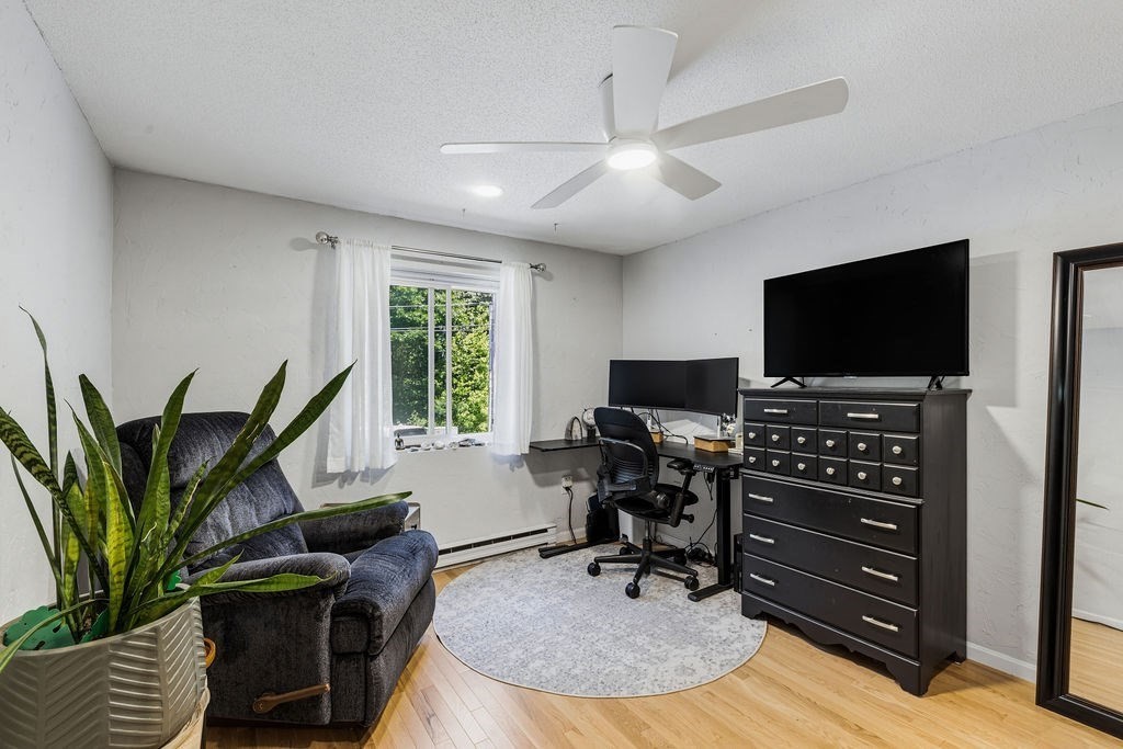 10 Erick Road, Unit 42 Mansfield, MA 02048 - Photo 25 of 33 a view of a livingroom with workspace and a flat screen tv