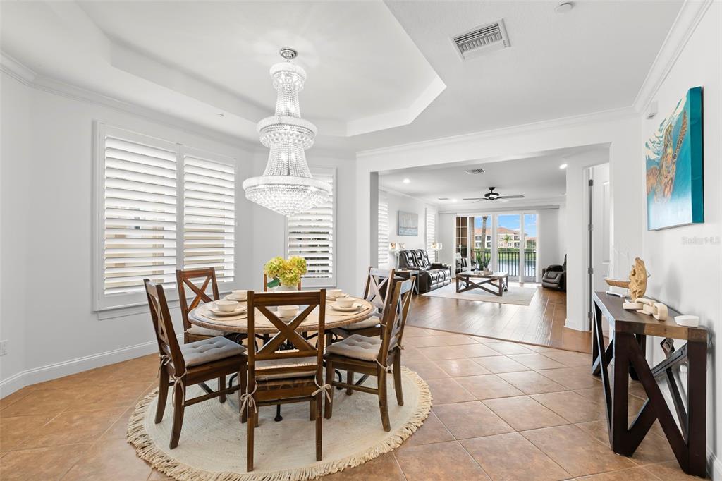 6 Academy Way, Unit 221 St. Petersburg, FL 33711 - Photo 11 of 64 a view of a dining room with furniture and chandelier