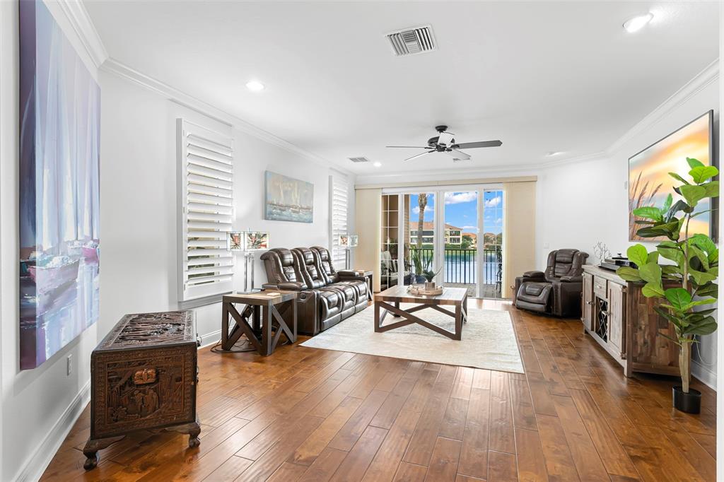 6 Academy Way, Unit 221 St. Petersburg, FL 33711 - Photo 16 of 64 a living room with furniture large window and wooden floor