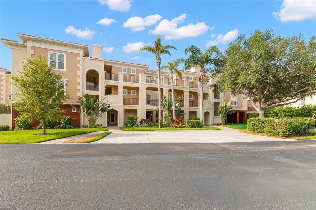 6 Academy Way, Unit 221 St. Petersburg, FL 33711 - Photo 7 of 64 a front view of a building with an outdoor space and trees