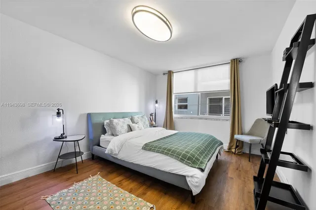 a bedroom with a bed window and a chair