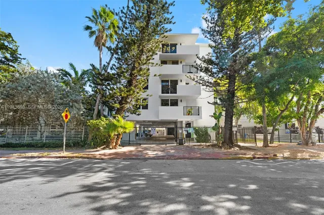 a view of a house with a tree in front