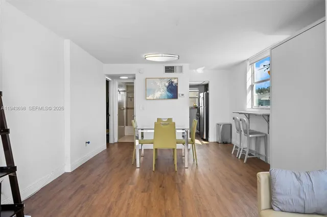 a dining room with furniture and wooden floor