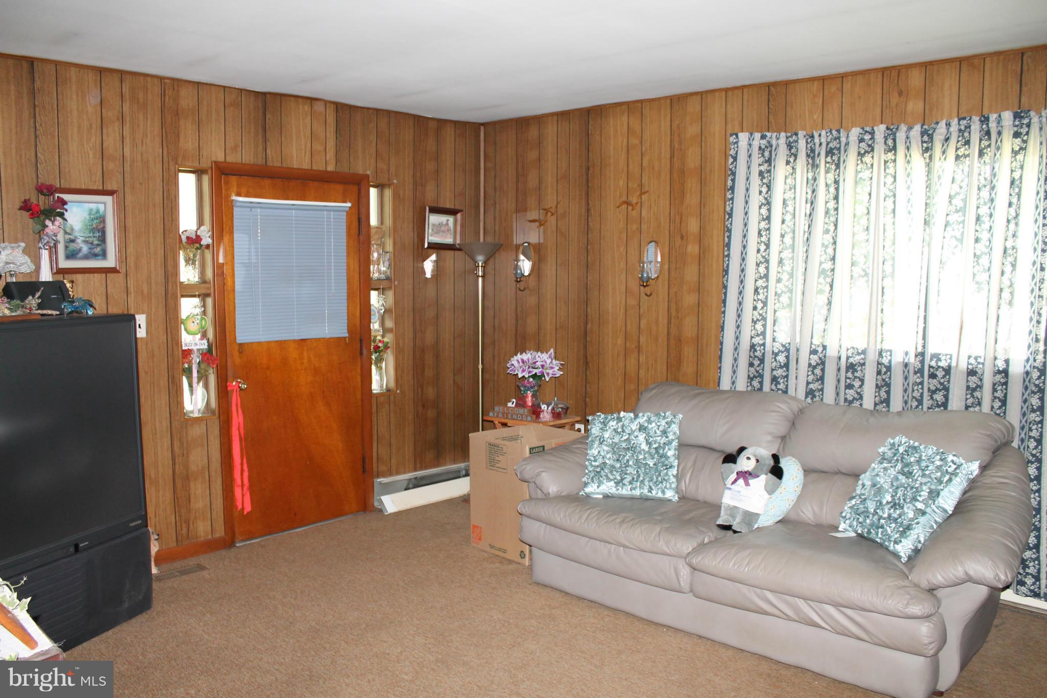 2335 Poplar Road Baltimore, MD 21221 - Photo 3 of 15 a living room with furniture and a chandelier