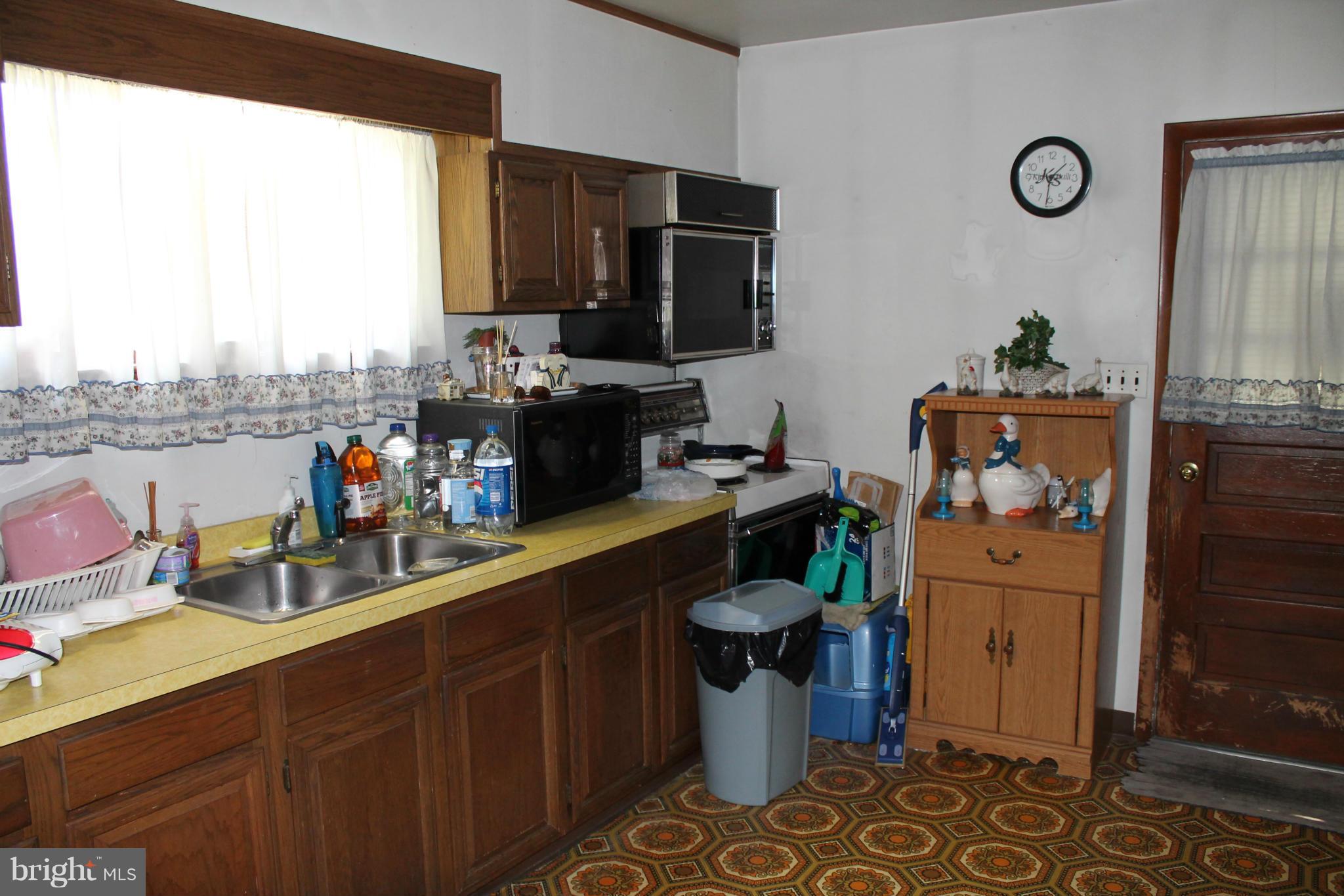 2335 Poplar Road Baltimore, MD 21221 - Photo 5 of 15 a kitchen with a sink appliances and cabinets