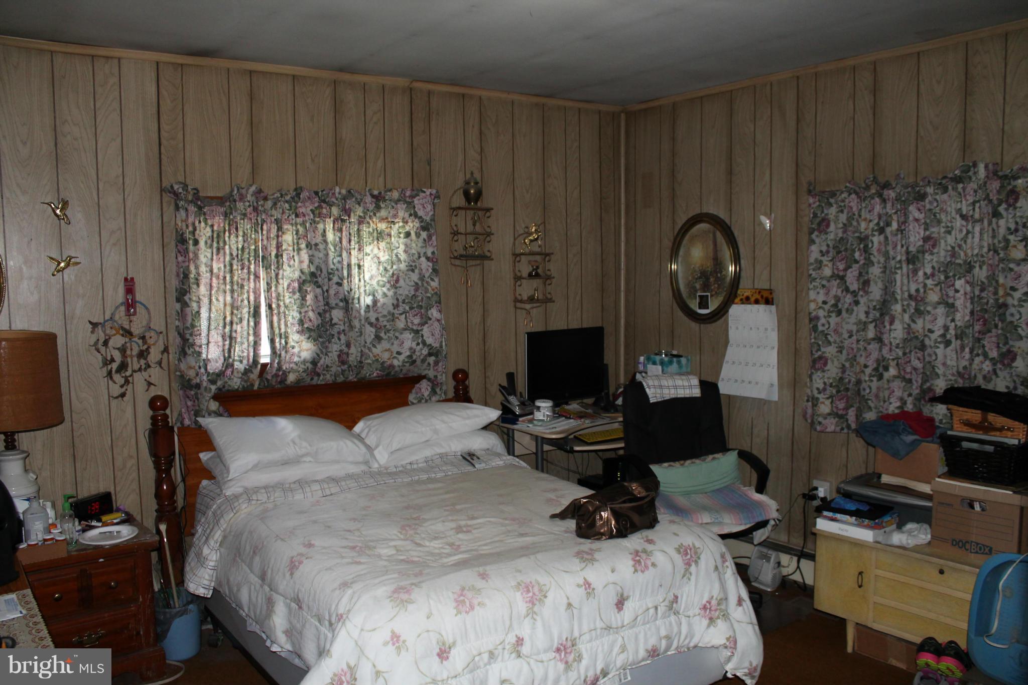2335 Poplar Road Baltimore, MD 21221 - Photo 7 of 15 a bedroom with bed and a chair