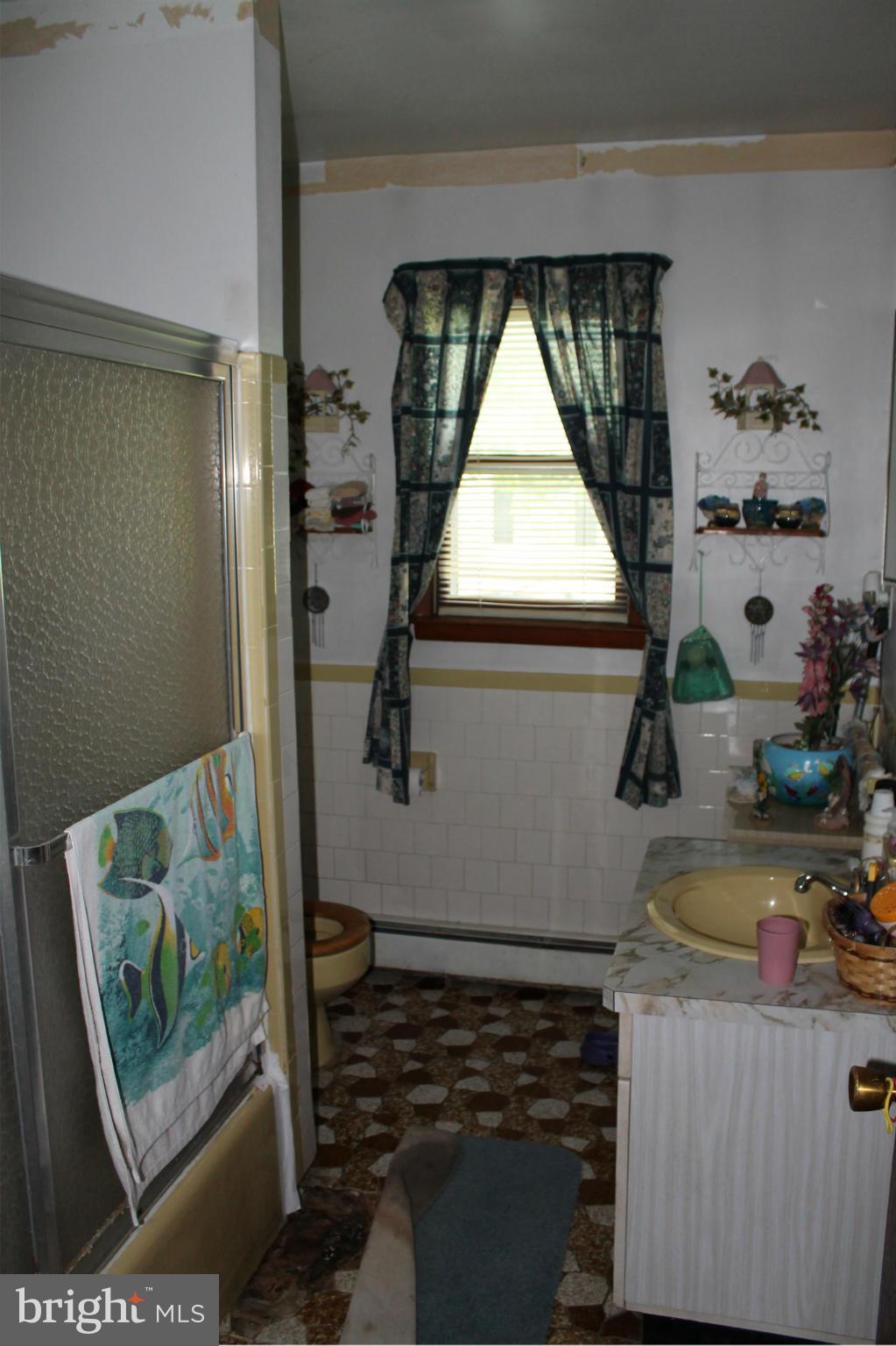 2335 Poplar Road Baltimore, MD 21221 - Photo 9 of 15 a bathroom with a sink and a window