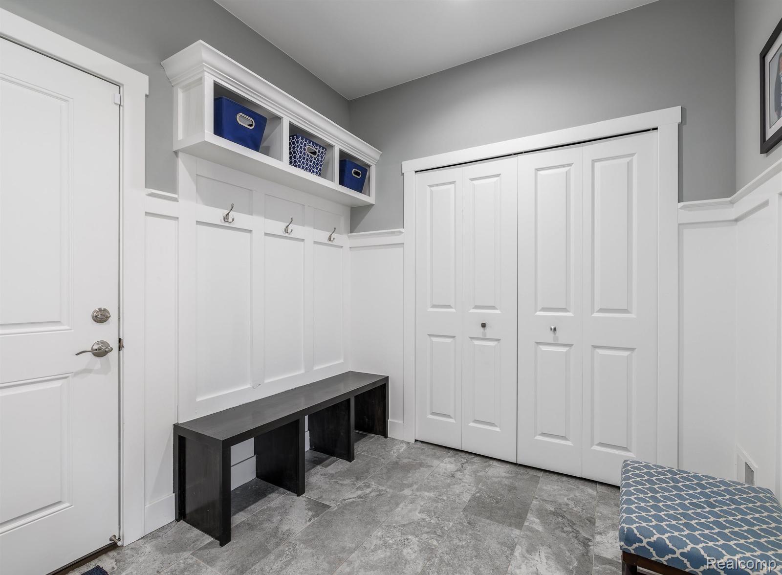 47705 Card Road Macomb, MI 48044 - Photo 21 of 53 Entryway featuring a built-in bench with coat hooks, an overhead storage shelf, and bi-fold closet doors