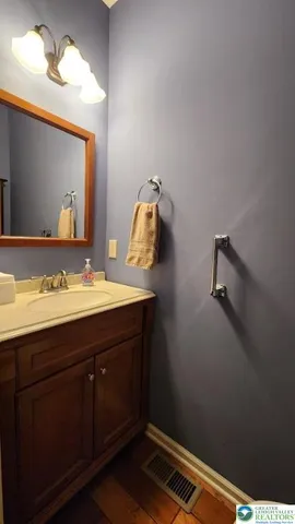 a bathroom with a sink vanity and mirror