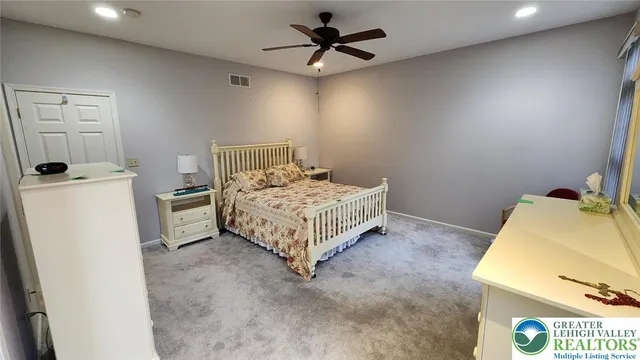 a bedroom with a bed and a table