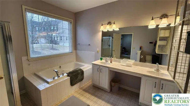 a bathroom with a sink double vanity granite and a mirror