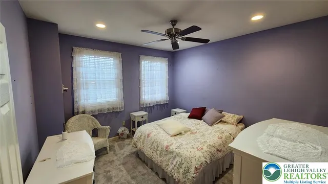 a bed room with two bed and a chandelier