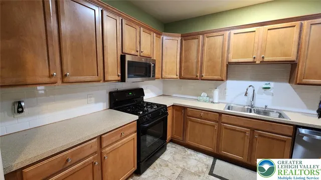 a kitchen with a sink cabinets and appliances