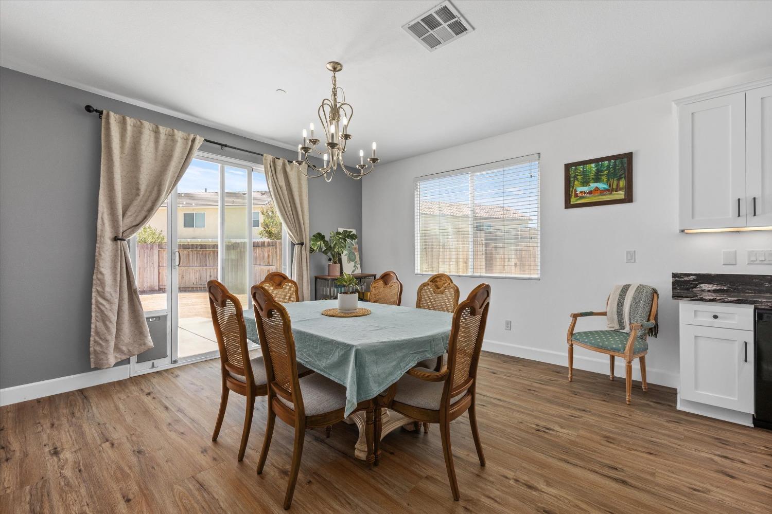 5407 Mensen Drive Bakersfield, CA 93313 - Photo 16 of 36 a view of a dining room with furniture window and wooden floor