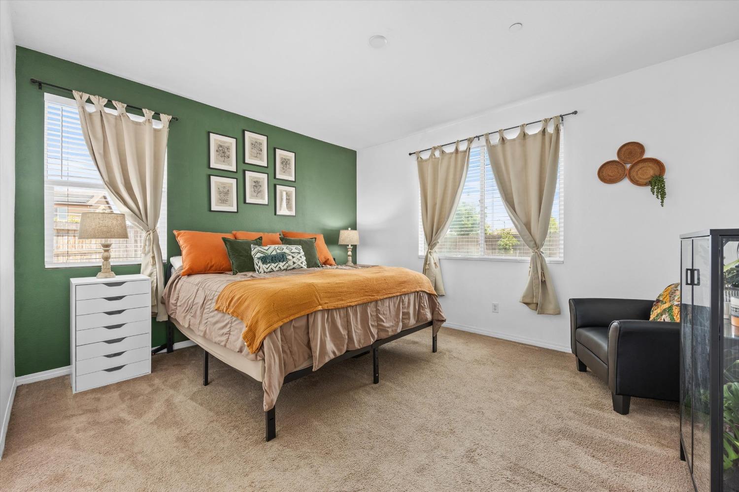 5407 Mensen Drive Bakersfield, CA 93313 - Photo 17 of 36 a bedroom with a bed and a dresser next to a window