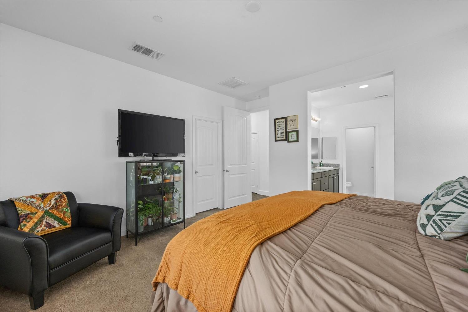 5407 Mensen Drive Bakersfield, CA 93313 - Photo 18 of 36 a bedroom with a bed and a television