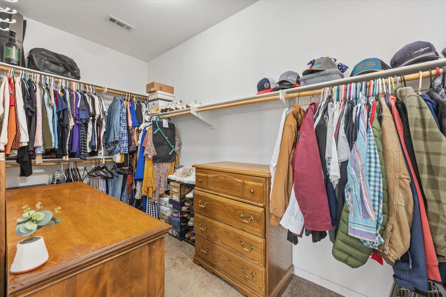 5407 Mensen Drive Bakersfield, CA 93313 - Photo 21 of 36 a view of walk in closet with clothes and shoes