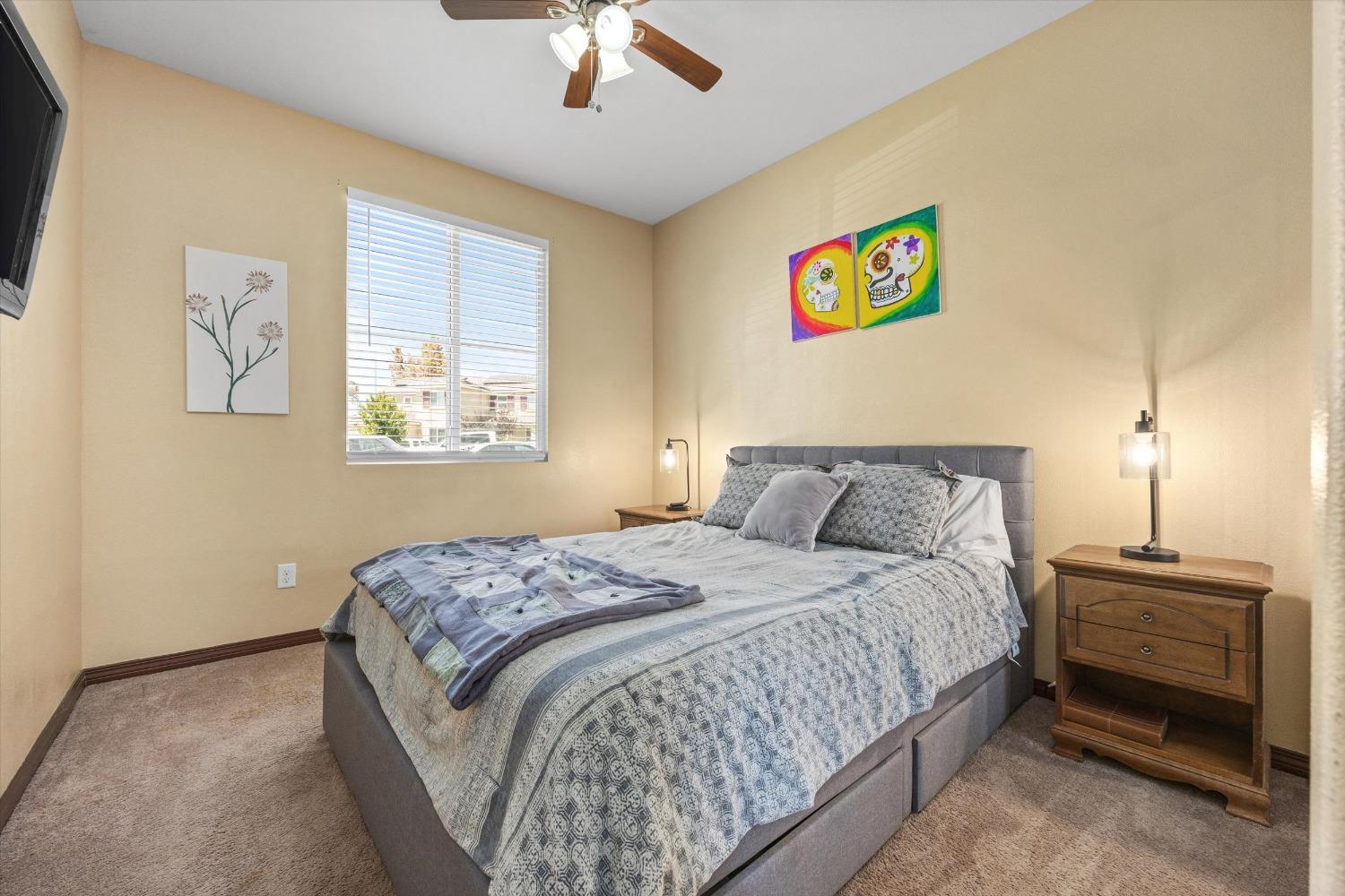 5407 Mensen Drive Bakersfield, CA 93313 - Photo 24 of 36 a bedroom with a bed and a chandelier