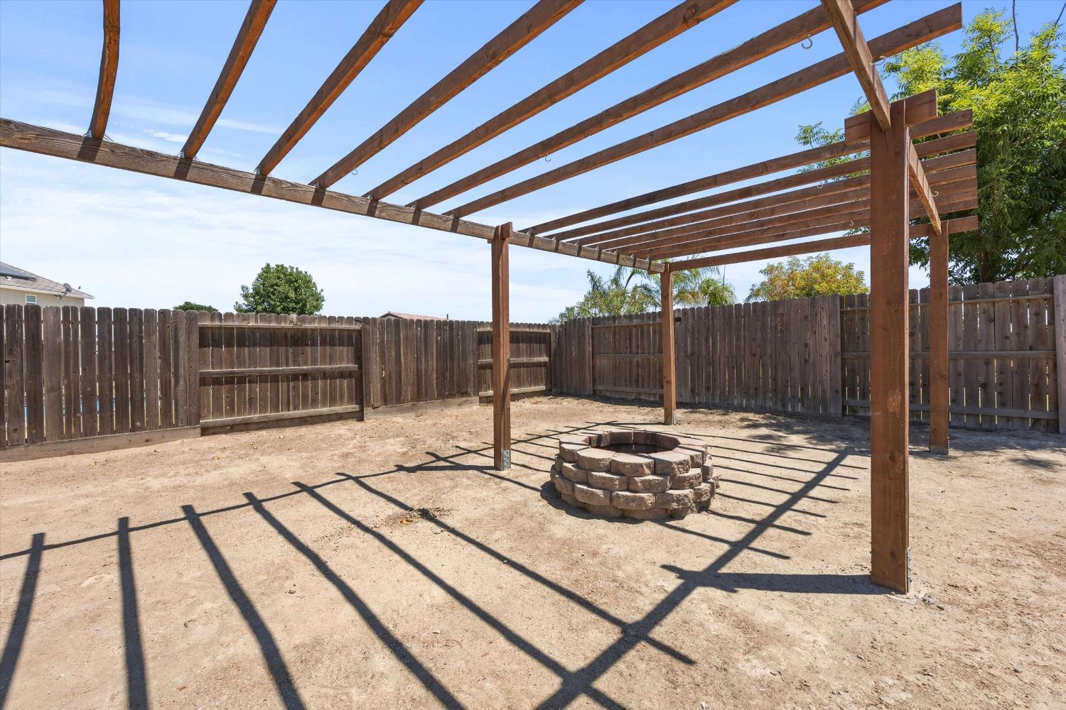 5407 Mensen Drive Bakersfield, CA 93313 - Photo 31 of 36 a view of backyard with wooden fence
