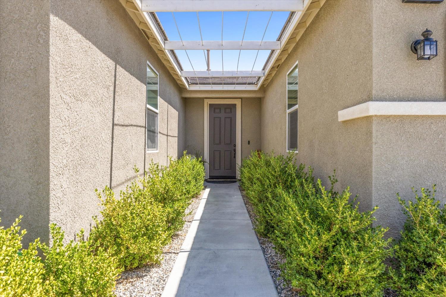 5407 Mensen Drive Bakersfield, CA 93313 - Photo 4 of 36 a view of a pathway along with potted plants