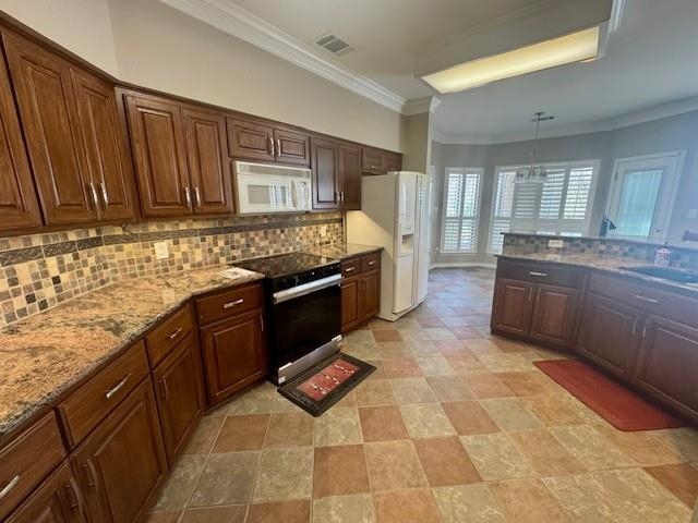 407 Quick Silver Horseshoe Bay, TX 78657 - Photo 13 of 31 a kitchen with stainless steel appliances granite countertop a stove a sink and a microwave