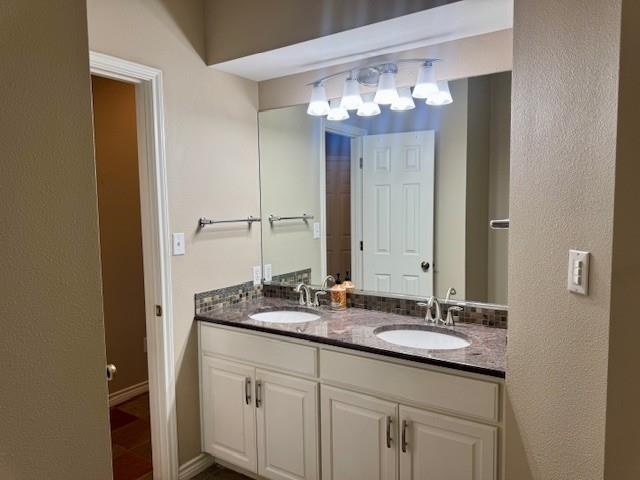 407 Quick Silver Horseshoe Bay, TX 78657 - Photo 24 of 31 a bathroom with a granite countertop sink a large mirror and a shower