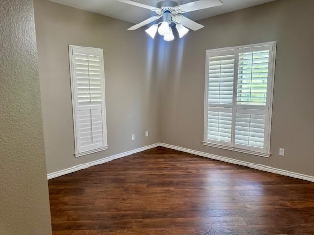 407 Quick Silver Horseshoe Bay, TX 78657 - Photo 26 of 31 an empty room with wooden floor chandelier fan and windows