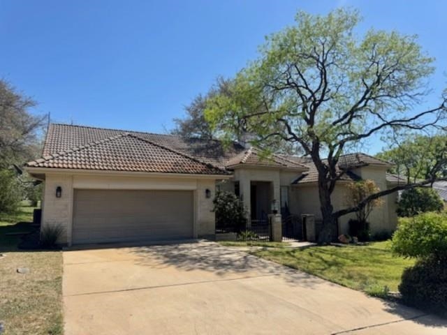 407 Quick Silver Horseshoe Bay, TX 78657 - Photo 3 of 31 a front view of a house with a garden