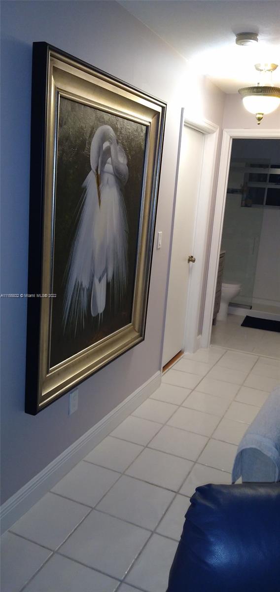 Lakes on the Green Hialeah, FL 33018 - Photo 12 of 24 a view of a hallway with paintings on the wall