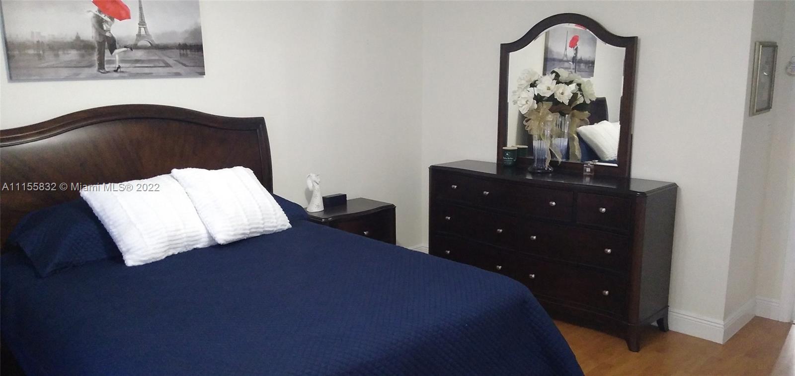 Lakes on the Green Hialeah, FL 33018 - Photo 14 of 24 a bedroom with a bed and a dresser