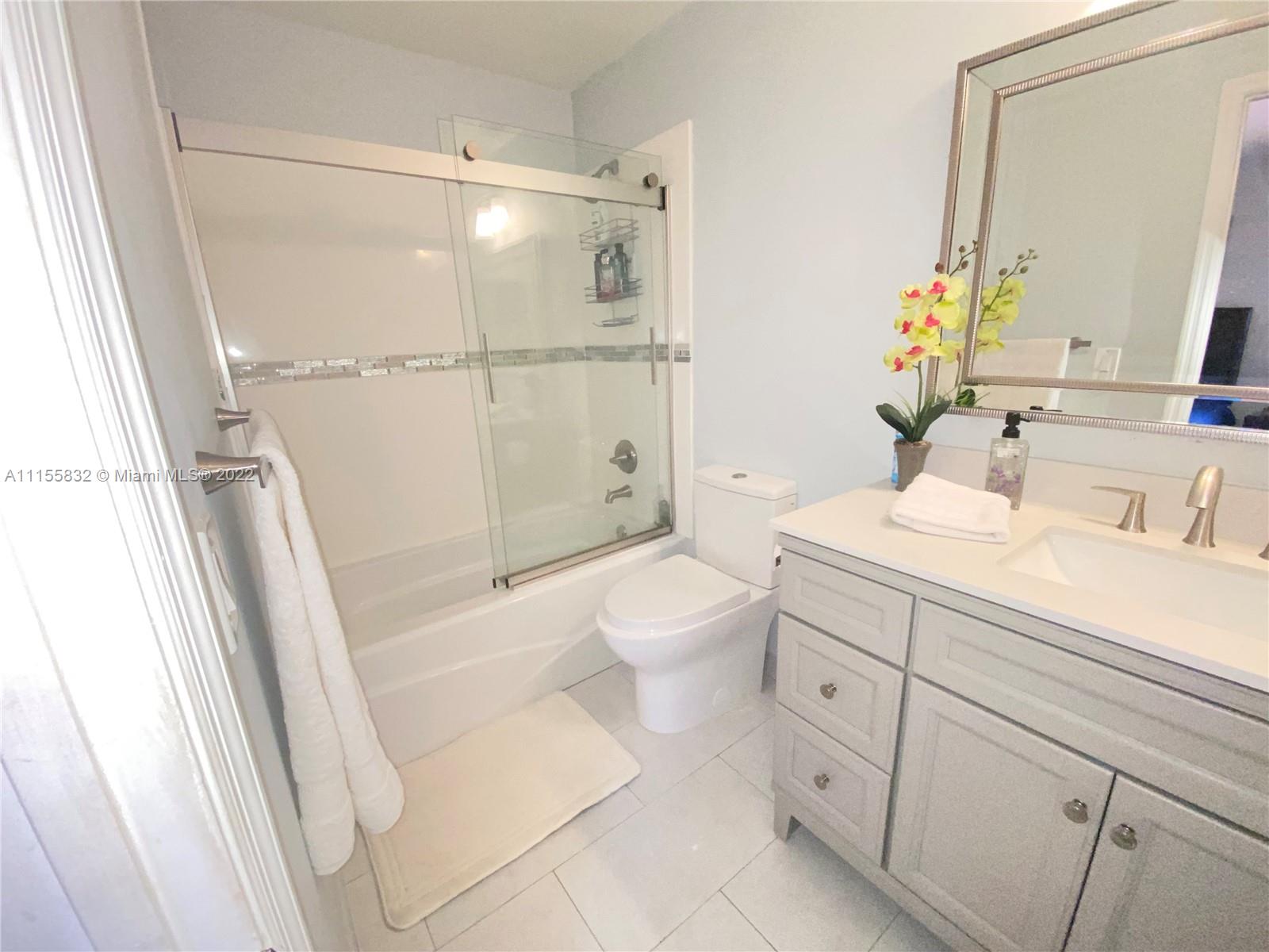 Lakes on the Green Hialeah, FL 33018 - Photo 16 of 24 a bathroom with a sink a toilet and shower