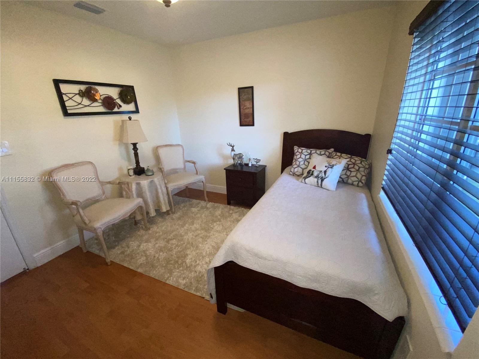 Lakes on the Green Hialeah, FL 33018 - Photo 18 of 24 a bedroom with bed and a couch