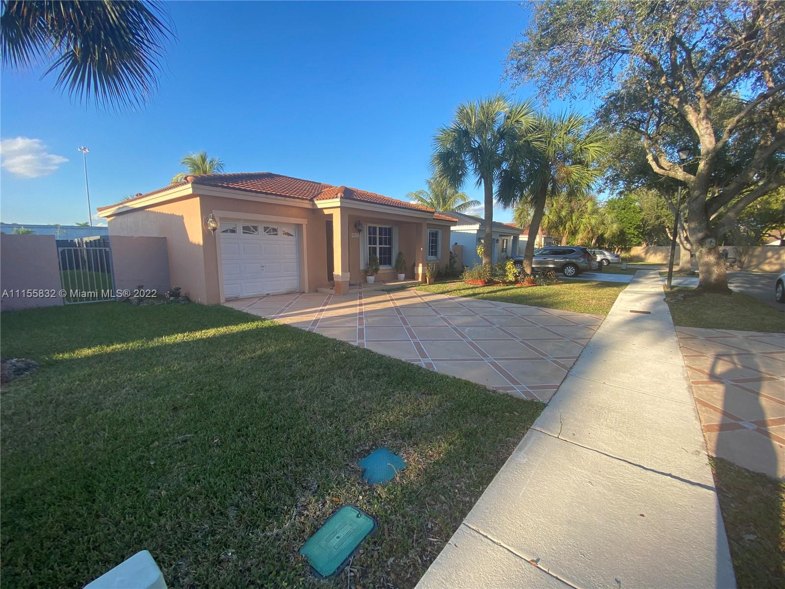 Lakes on the Green Hialeah, FL 33018 - Photo 2 of 24 a front view of a house with garden