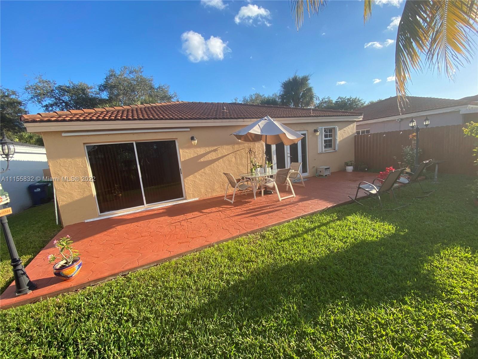 Lakes on the Green Hialeah, FL 33018 - Photo 21 of 24 a front view of a house with a yard