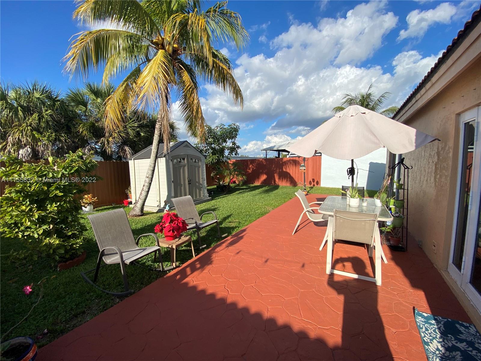 Lakes on the Green Hialeah, FL 33018 - Photo 22 of 24 a view of a backyard with sitting area
