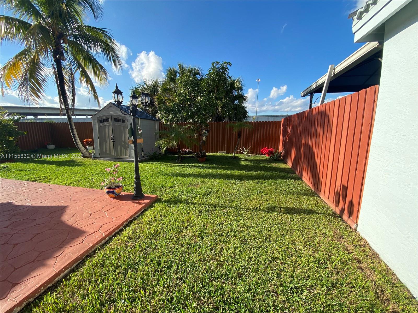 Lakes on the Green Hialeah, FL 33018 - Photo 23 of 24 a view of a backyard with a garden