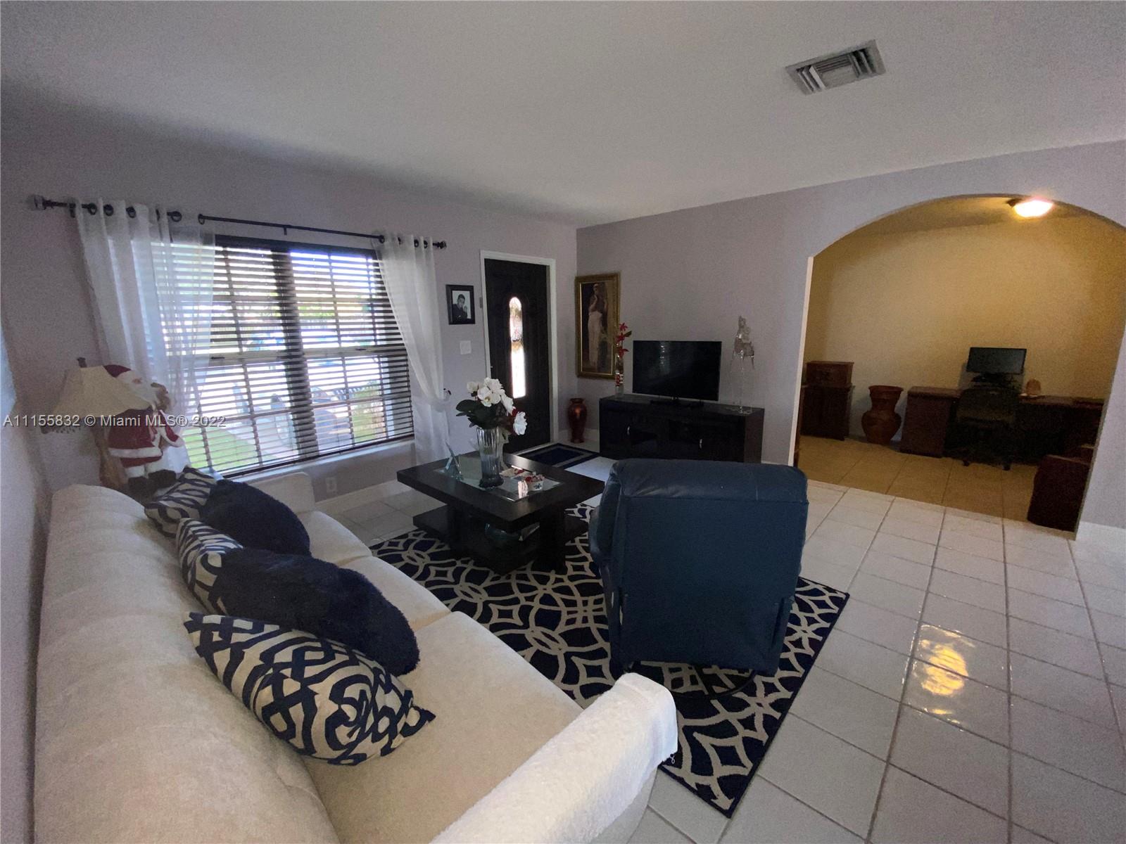 Lakes on the Green Hialeah, FL 33018 - Photo 4 of 24 a living room with furniture and a large window