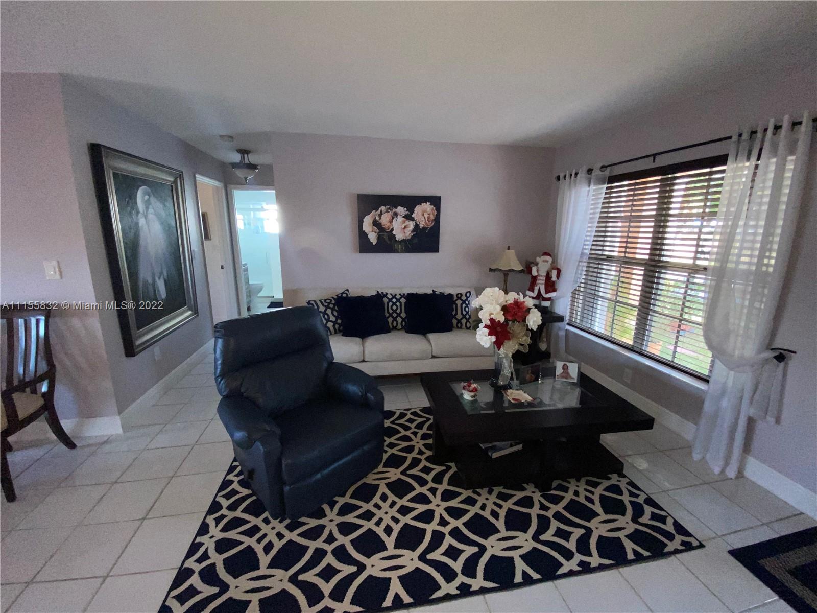 Lakes on the Green Hialeah, FL 33018 - Photo 5 of 24 a living room with furniture and a window