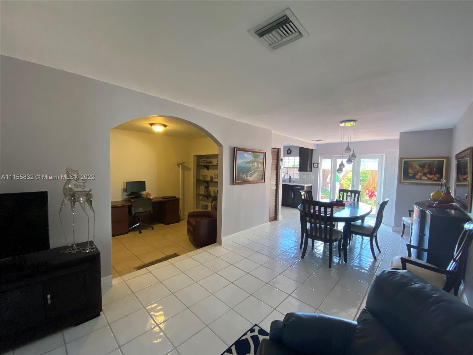 Lakes on the Green Hialeah, FL 33018 - Photo 6 of 24 a living room with furniture and a wooden floor