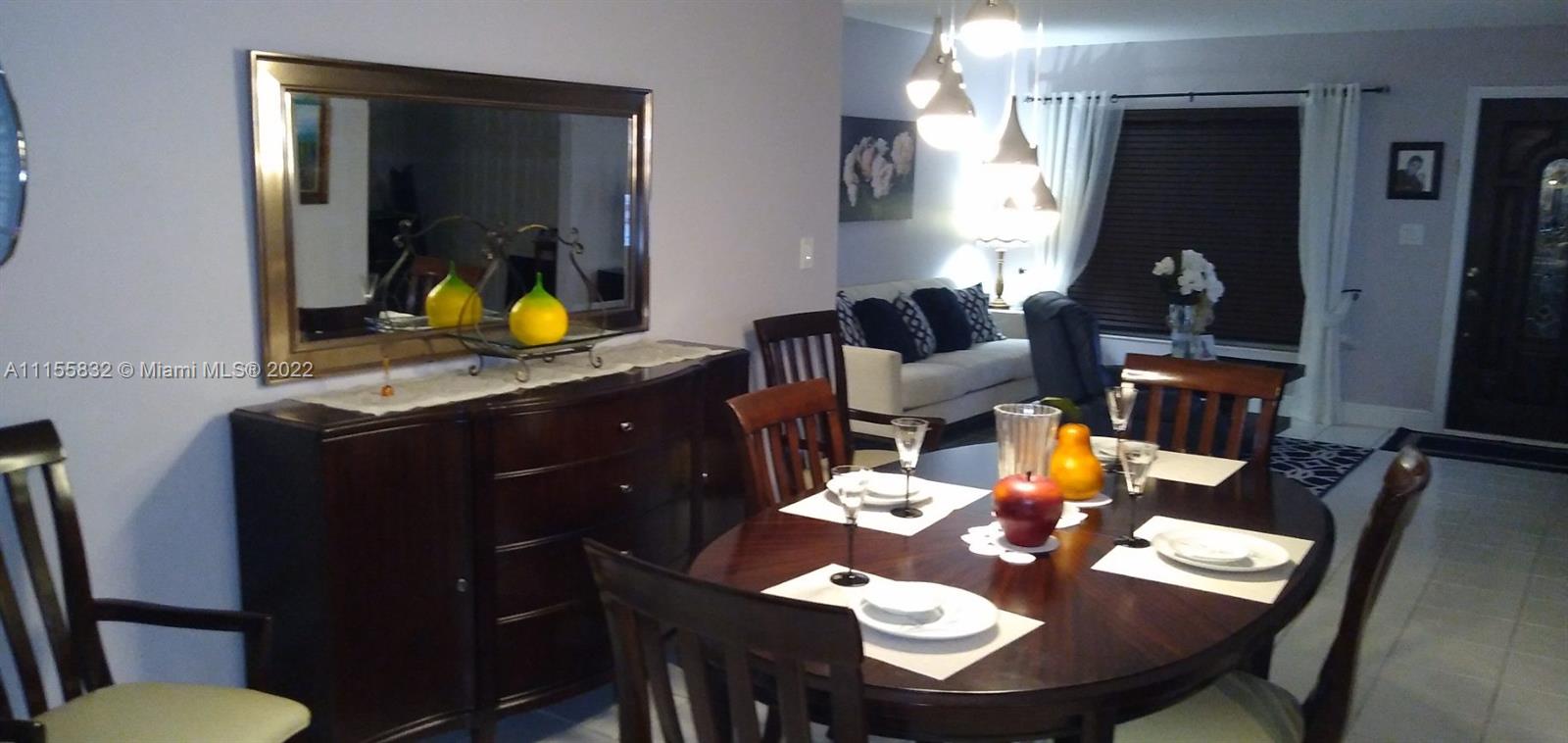 Lakes on the Green Hialeah, FL 33018 - Photo 8 of 24 a view of a dining room with furniture and wooden floor