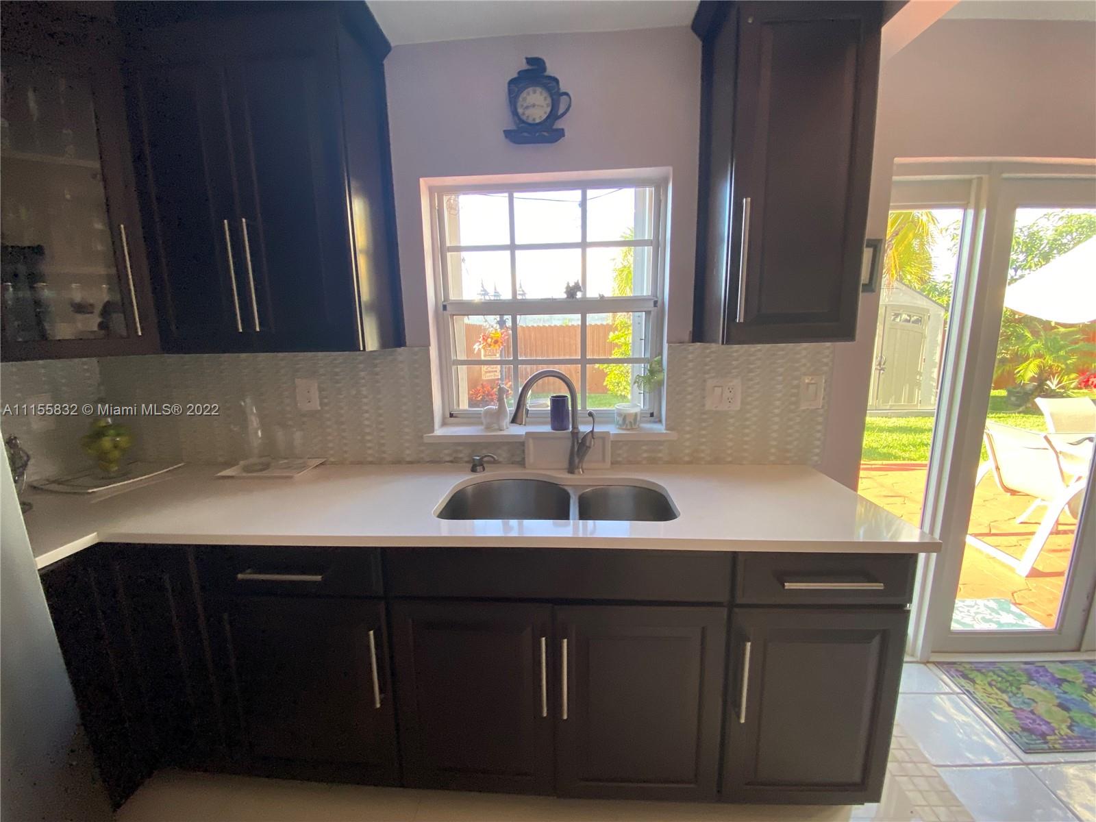 Lakes on the Green Hialeah, FL 33018 - Photo 10 of 24 a kitchen with a sink a window and a cabinets