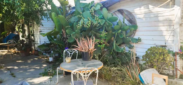 a backyard of a house with table and chairs