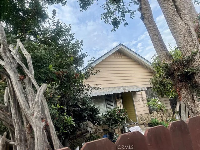 a front view of a house with trees