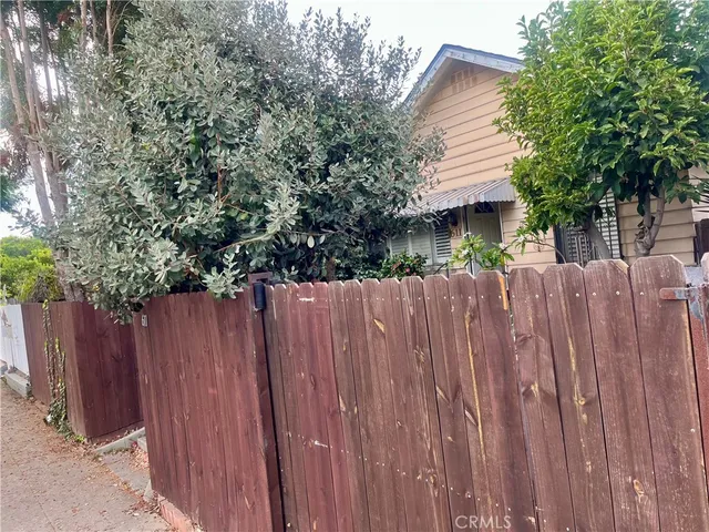 a view of a house with wooden fence