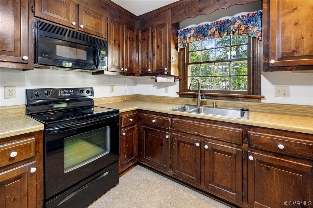 1806 Plain View Road Henrico, VA 23238 - Photo 12 of 33 a kitchen with wooden cabinets stove top oven and microwave