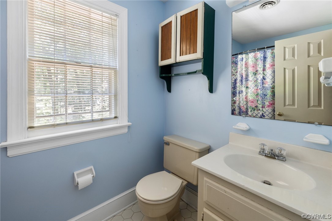 1806 Plain View Road Henrico, VA 23238 - Photo 22 of 33 a bathroom with a toilet a sink and a window